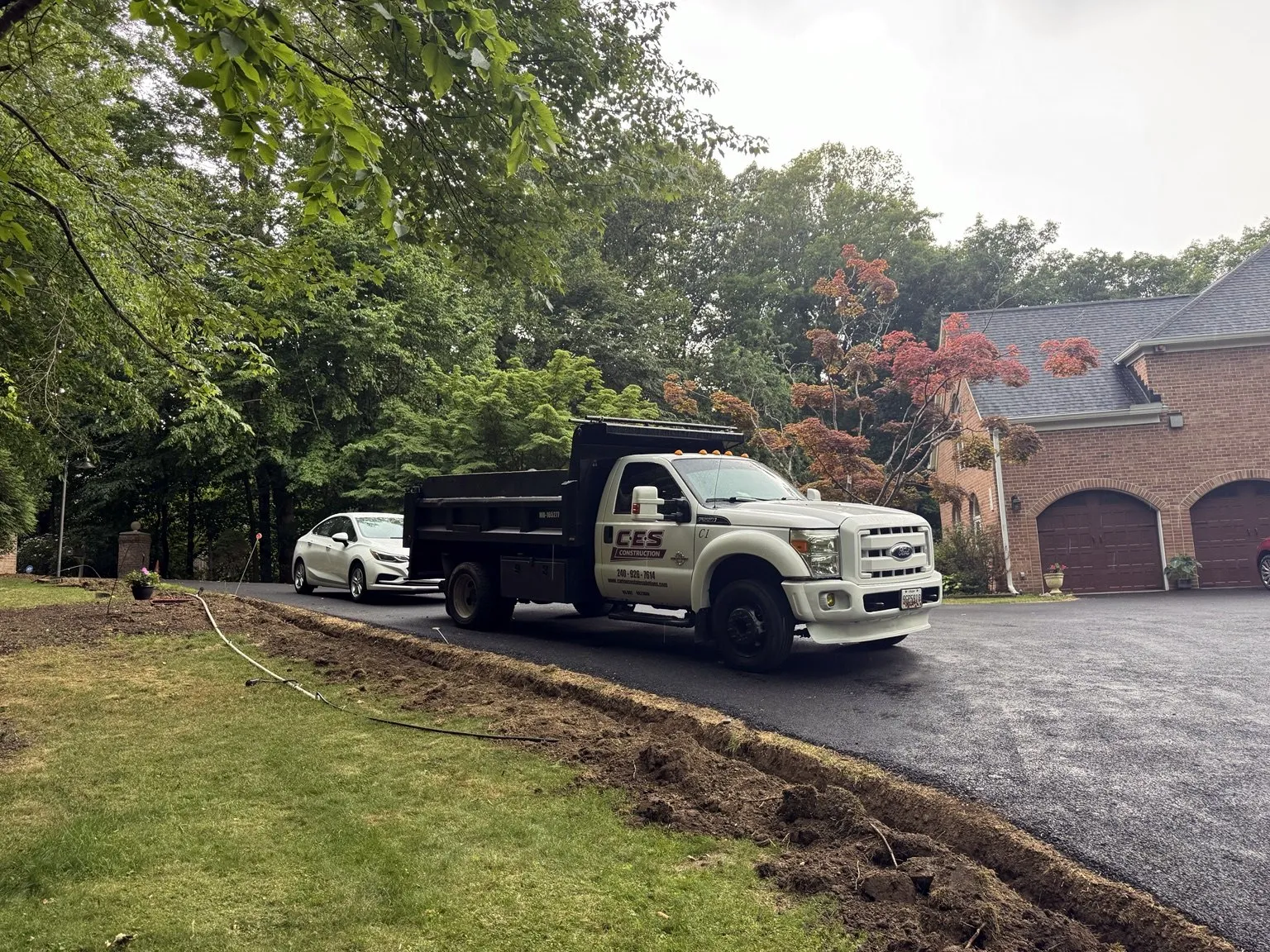CES Construction truck on a completed asphalt driveway