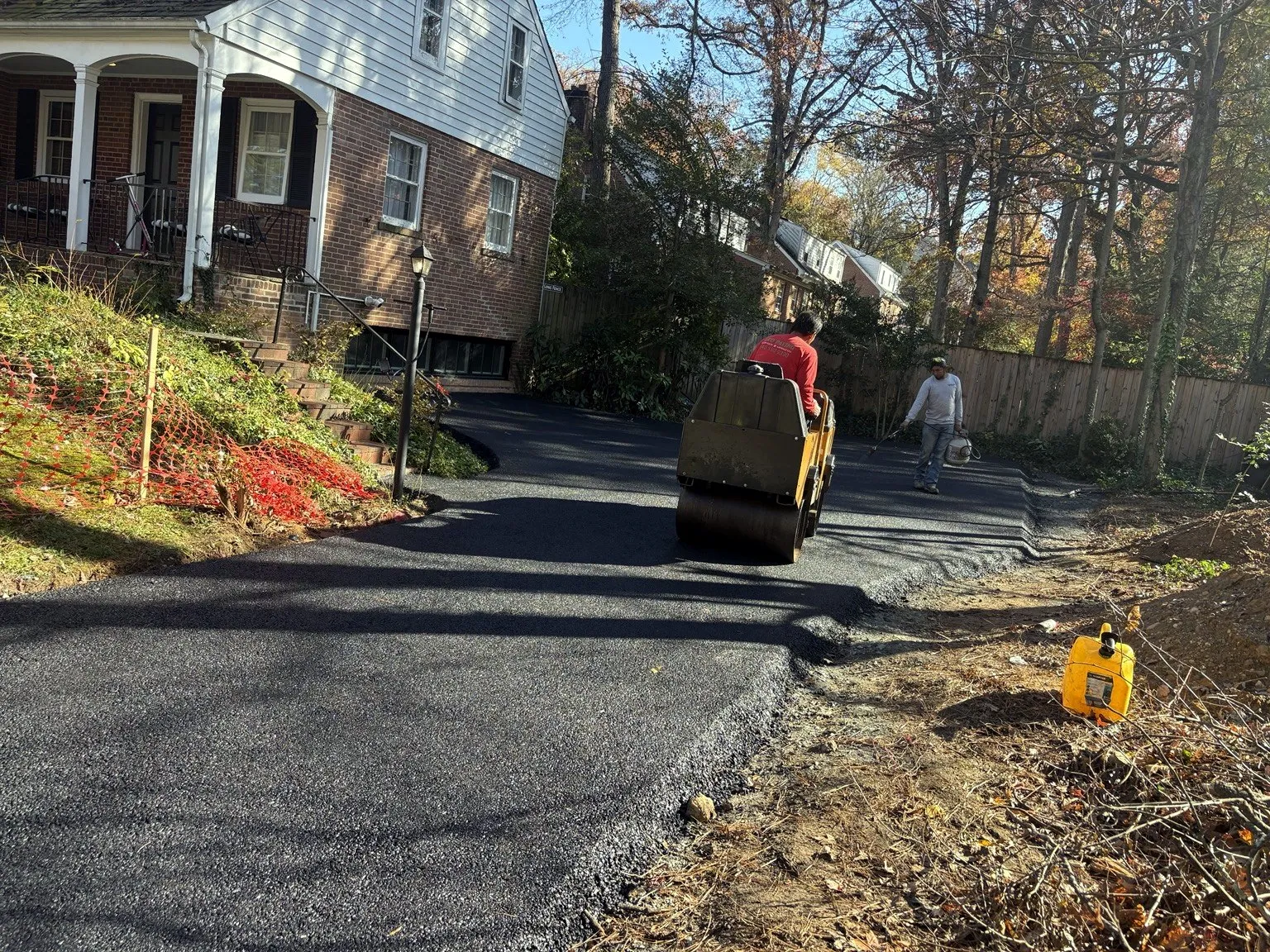 Asphalt driveway being rolled by CES Construction
