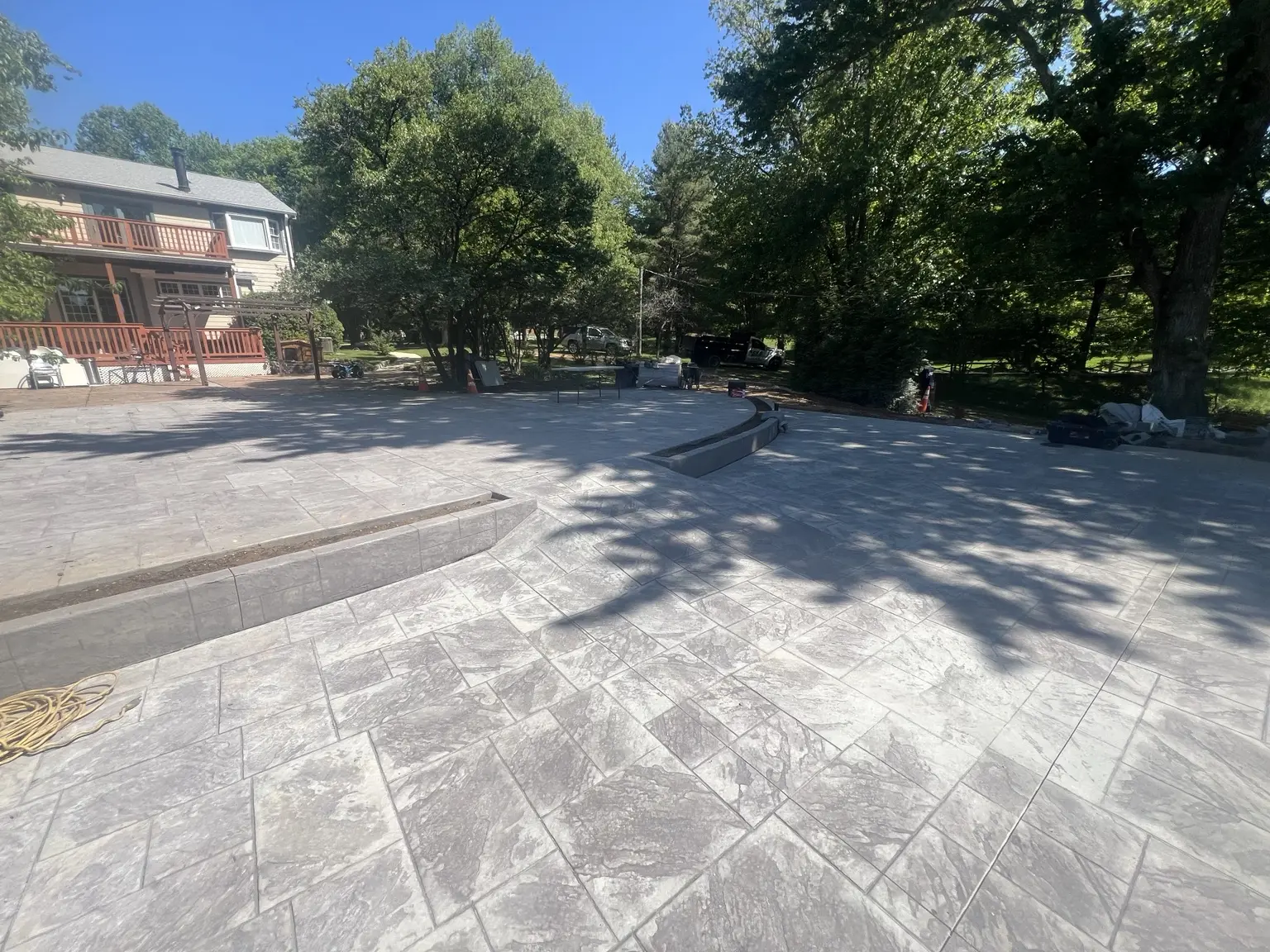 Large finished stamped-concrete patio with steps completed by CES Construction