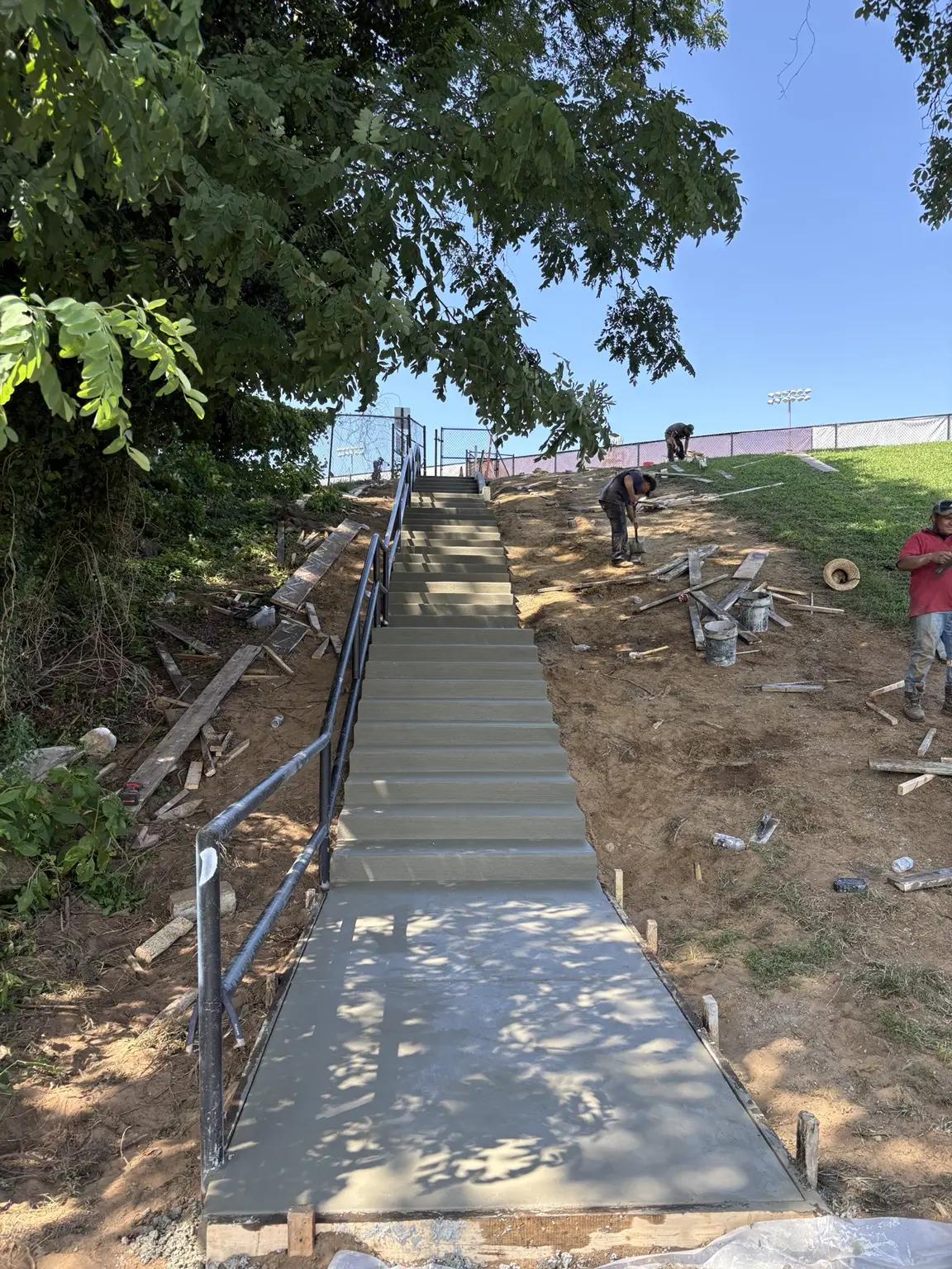 Completed long concrete stairway with exterior metal railings built by CES Construction