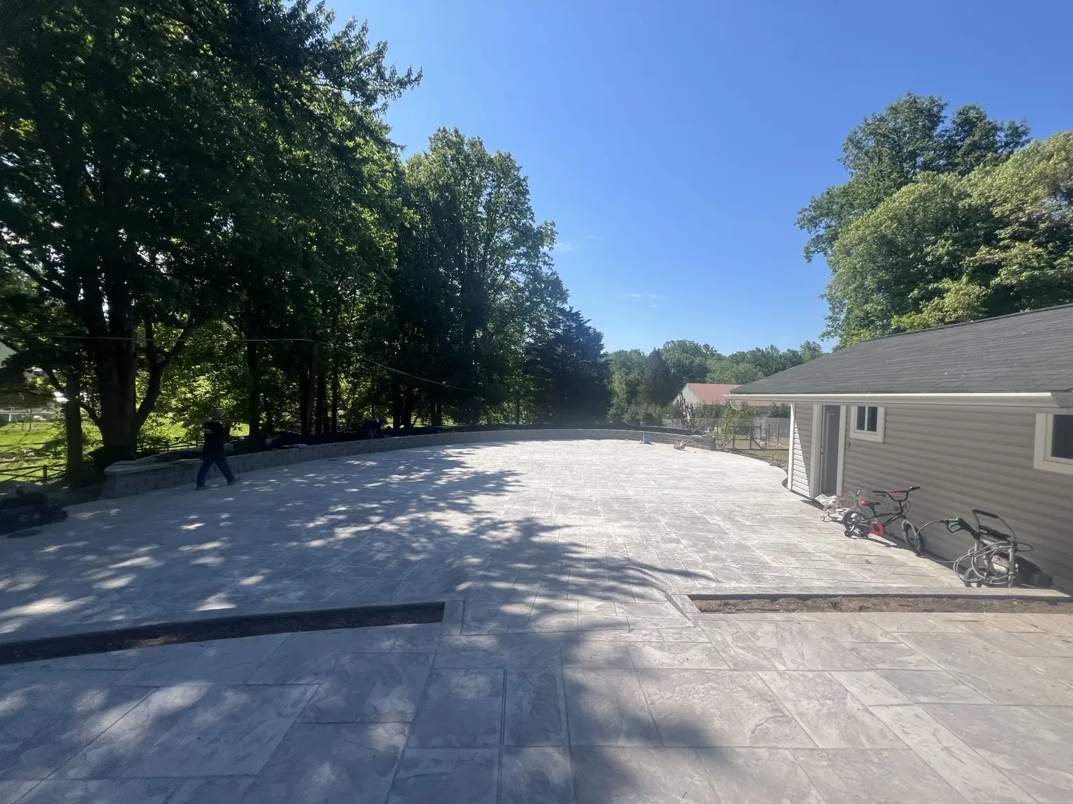 Wide finished stamped-concrete patio completed by CES Construction