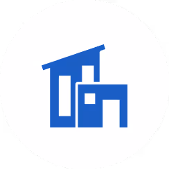 Blue icon of two stylized modern buildings inside a white circle.
