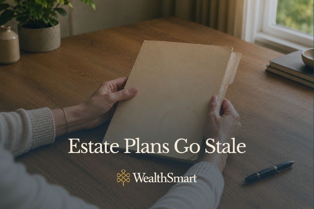 Hands holding a closed, worn folder on a wooden desk, representing an estate plan that hasn't been revisited in years
