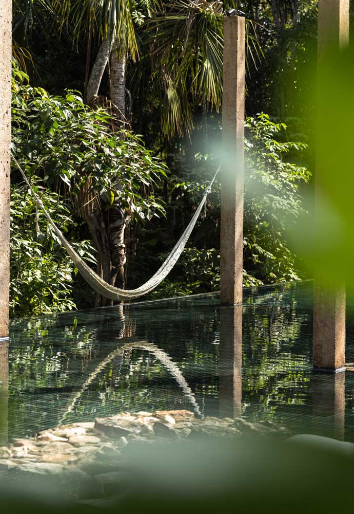 Infinity pool at La Valise Mazunte Hotel built into the natural rock face.