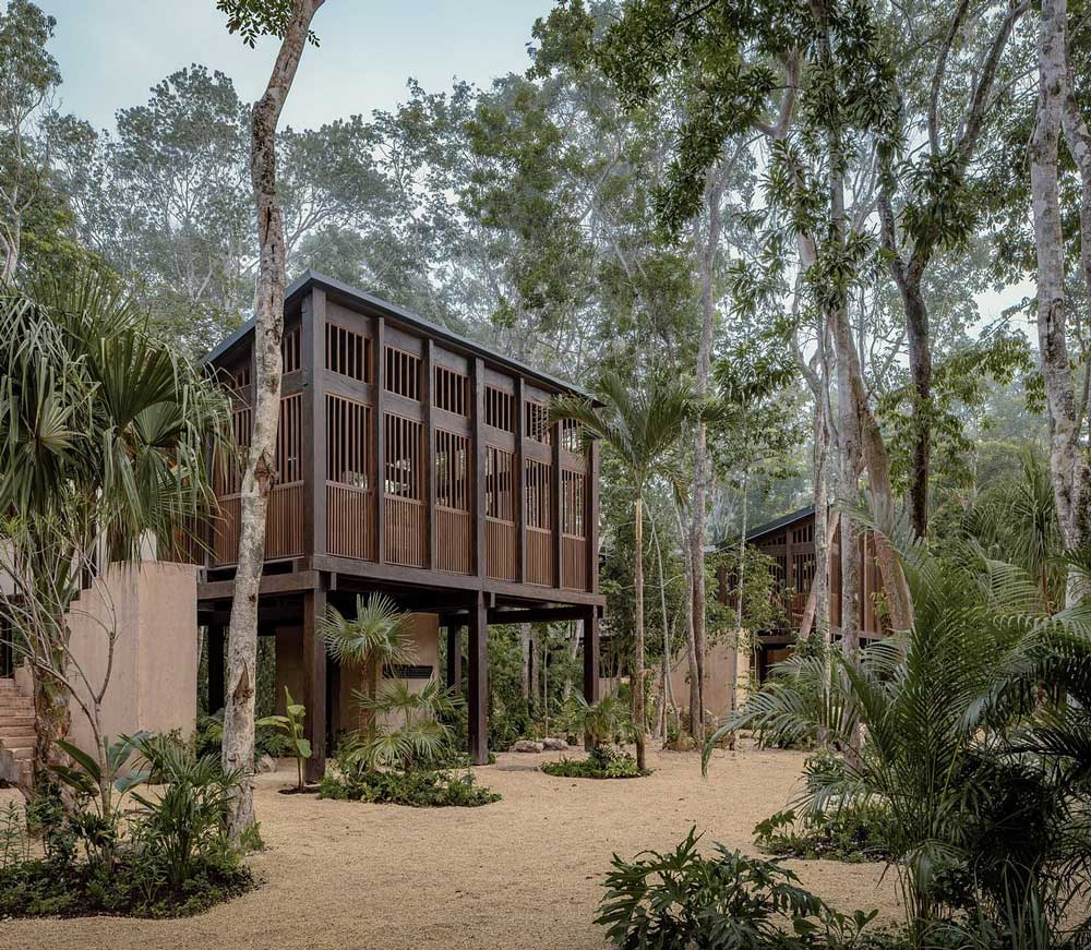 Exterior view of the luxury boutique at La Valise Tulum hotel surrounded by lush tropical jungle in Mexico.