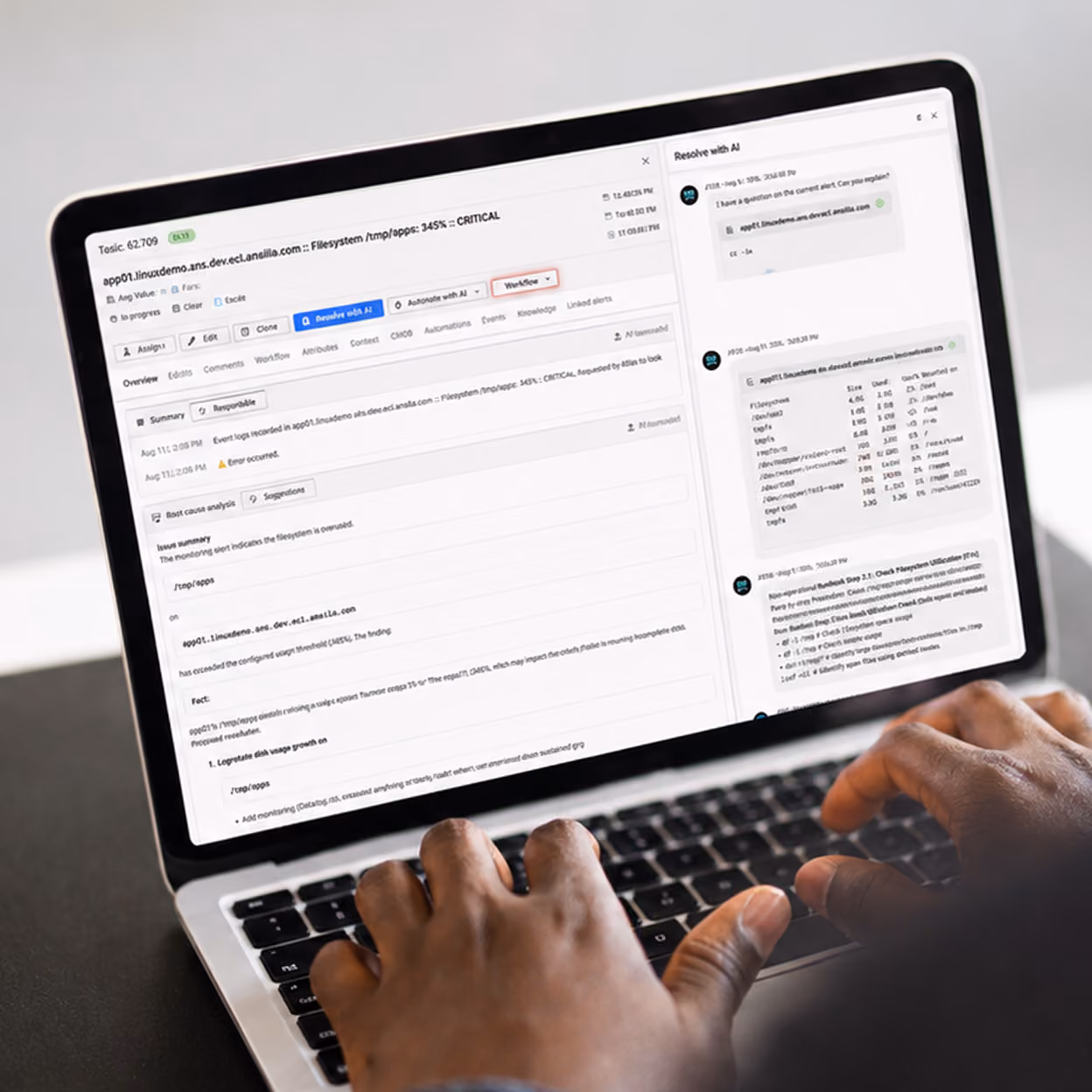 Person typing on a laptop showing a critical filesystem alert and AI-assisted resolution chat.