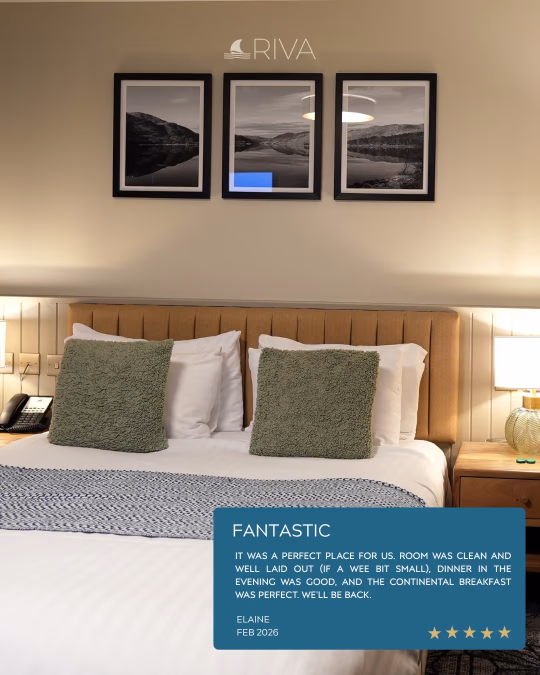 Hotel room with a large bed, two green pillows, nightstands, lamps, and framed landscape photos above headboard.