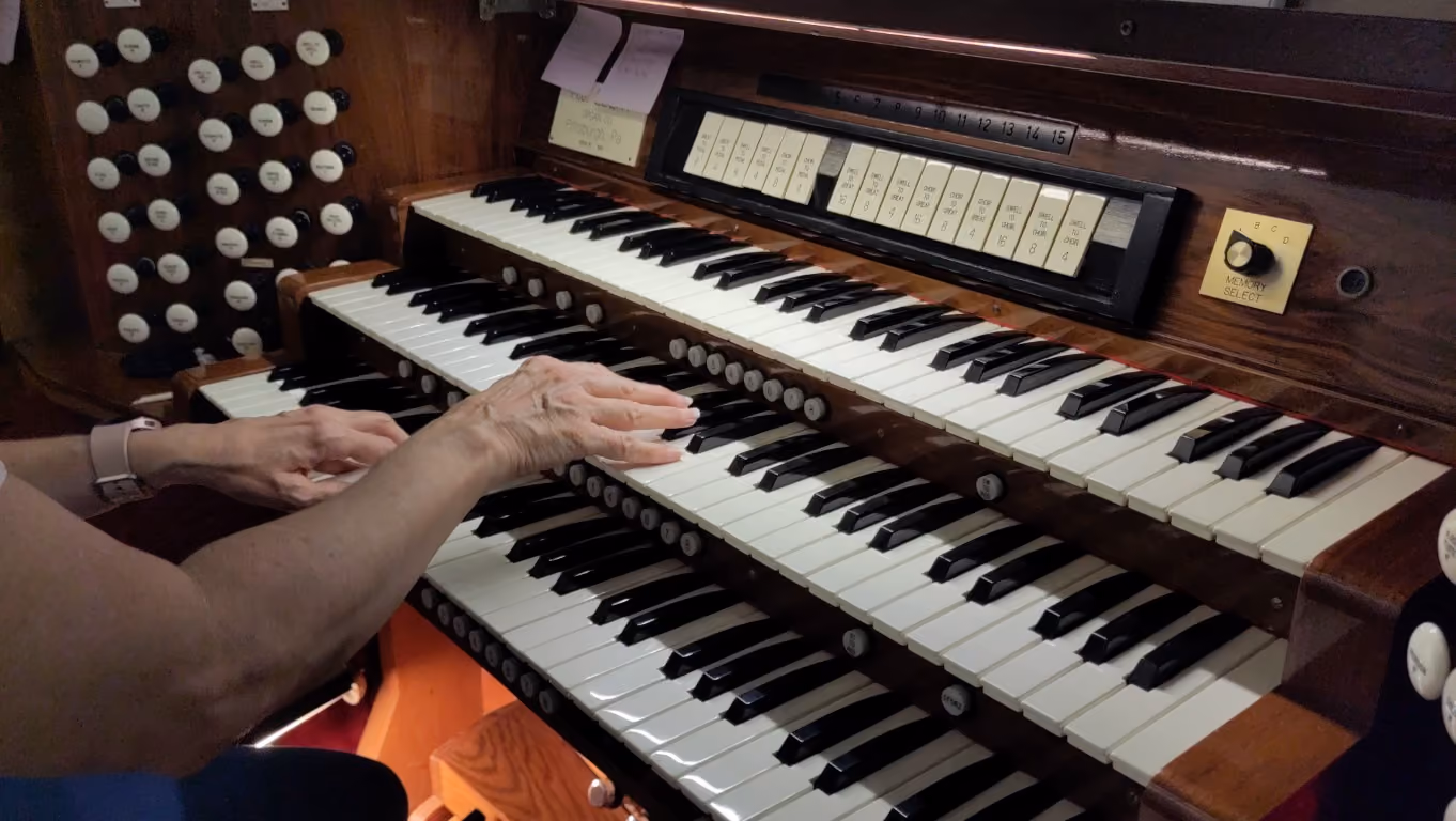 Donna practicing a hymn on the organ in the sanctuary.