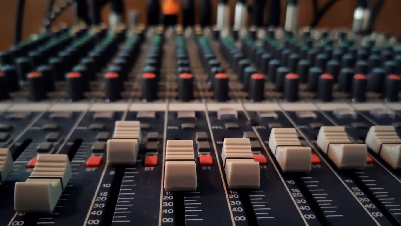 A close up photo of the dials of an audio-mixing board in the Church sanctuary.
