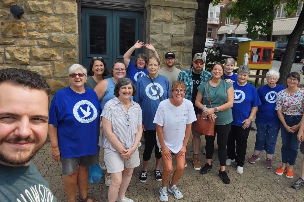 A large group of New Life members, volunteers, and neighbors smile for a photo at the Center of Bellevue.