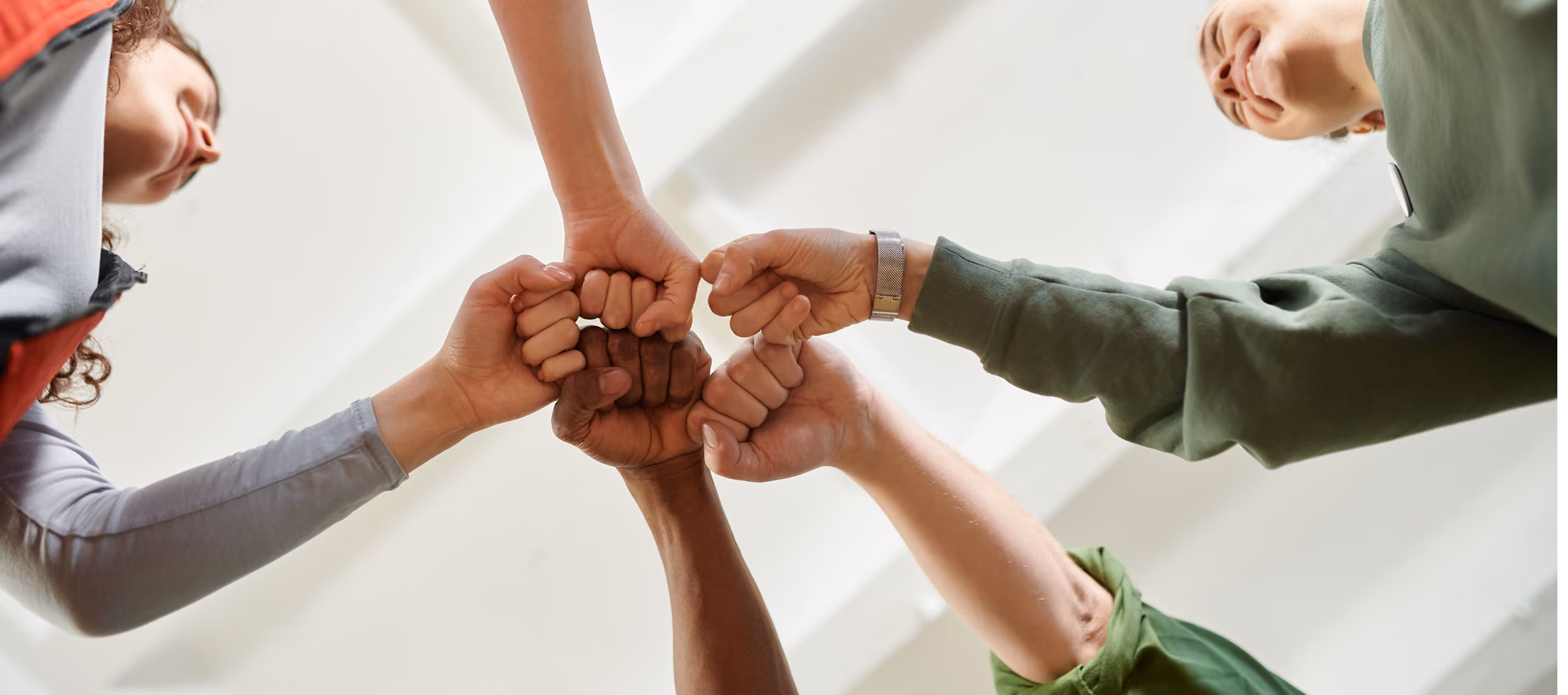 Community Outreach & Testing. Group of people fist bumping