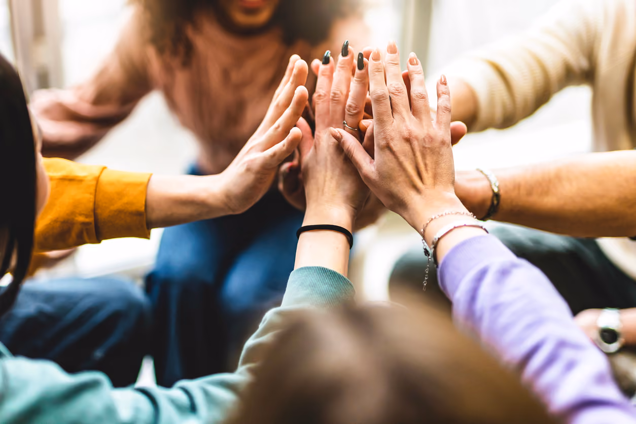Community Members With Hands Together