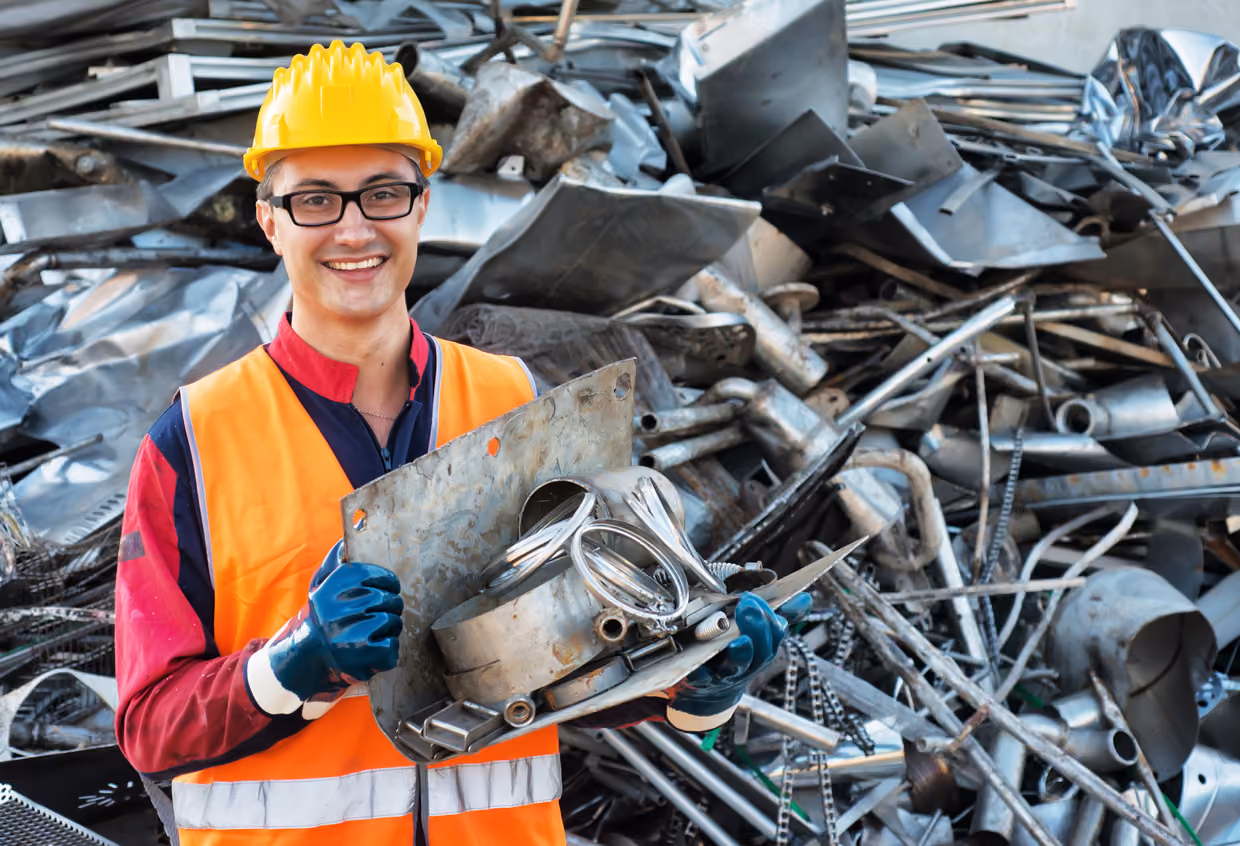 Worker holding a piece of recyclable steel
