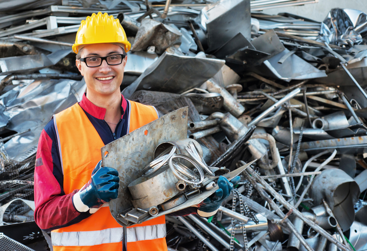 Worker holding a piece of recyclable steel