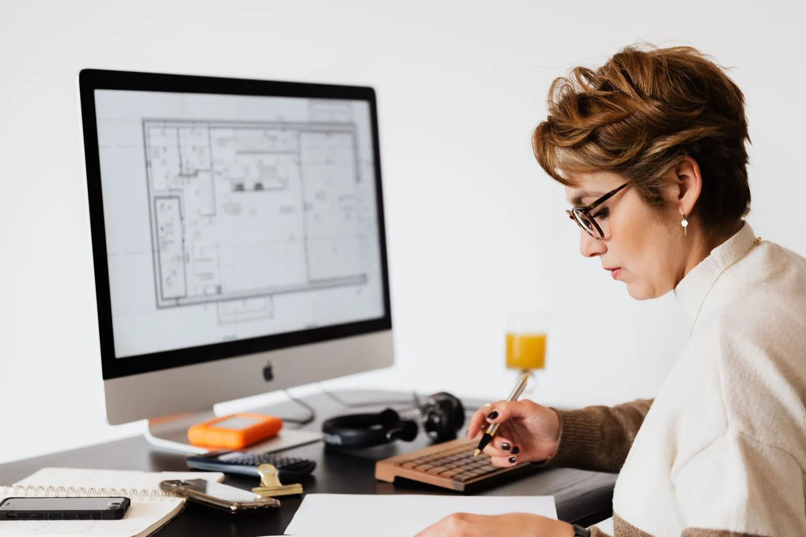 Self-employed person reviewing tax documents at a desk with a laptop