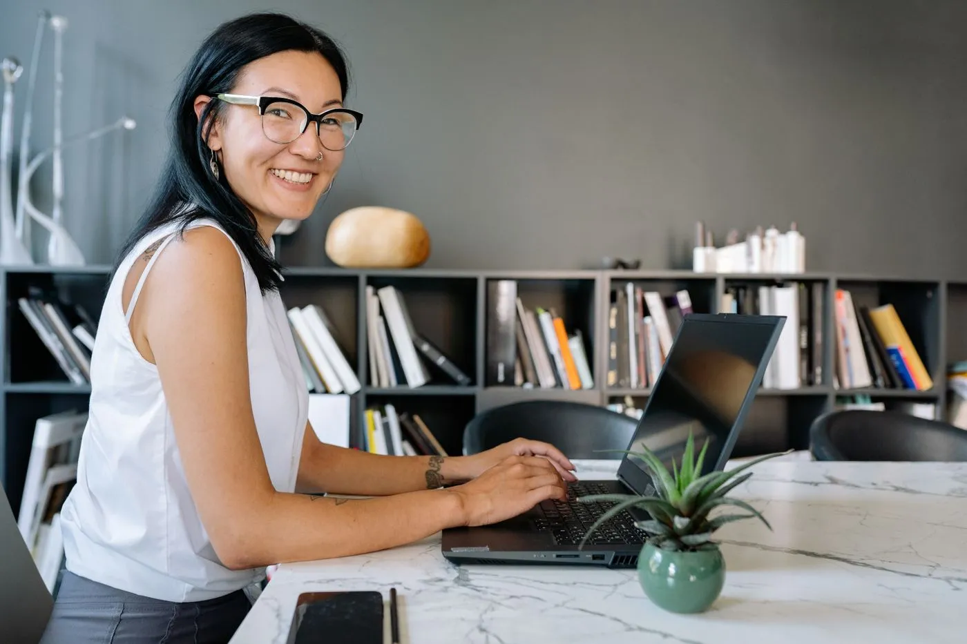 Woman smiling while filing her Canadian tax return on a laptop