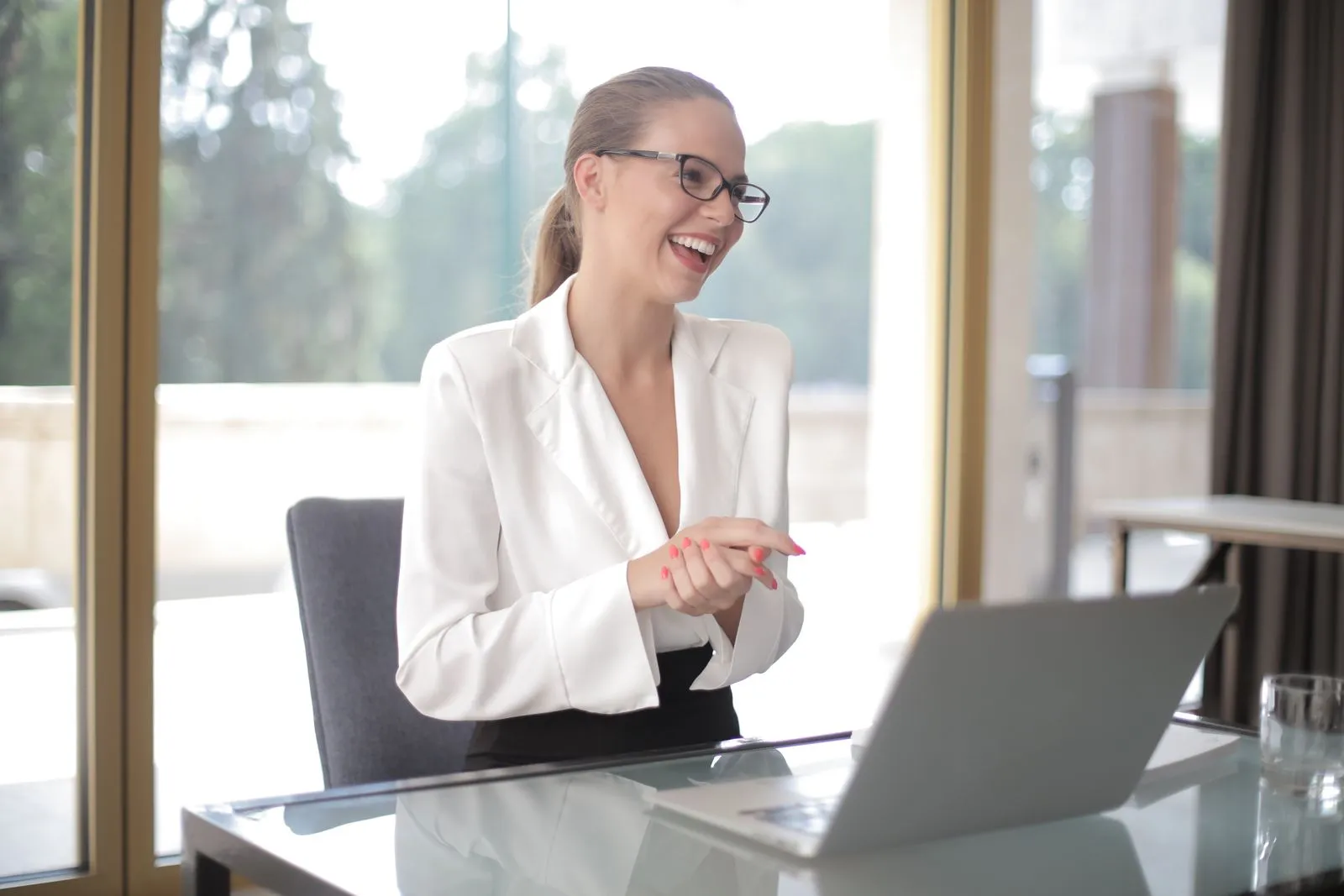 Bookkeeper running payroll on a laptop in a bright office