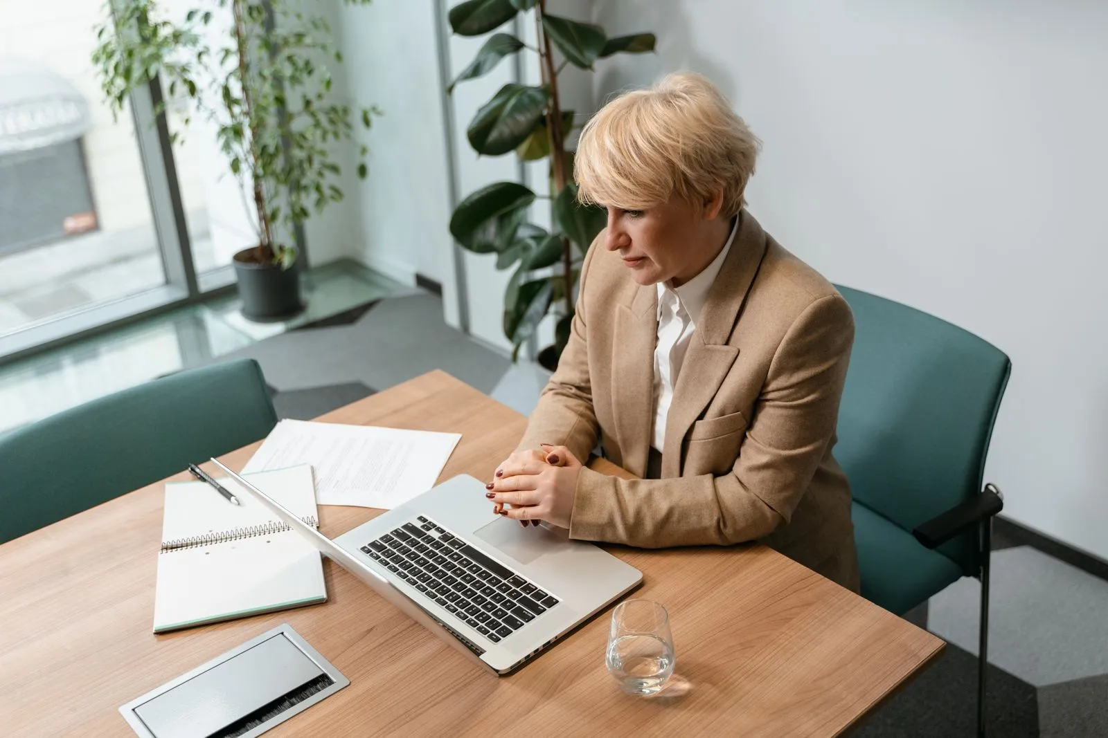 Payroll specialist processing a pay run at an office desk