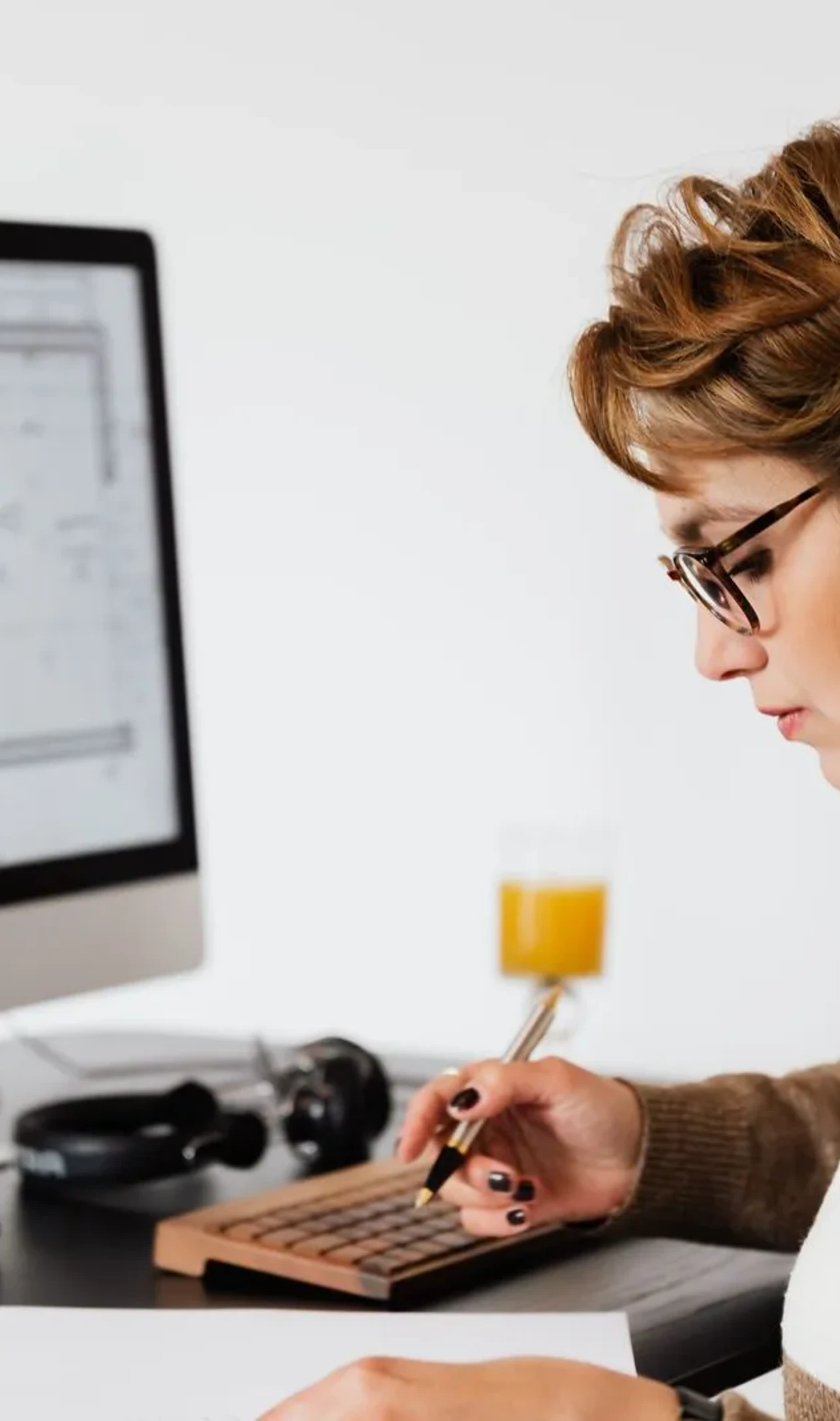 Self-employed person reviewing tax documents on a computer at a desk