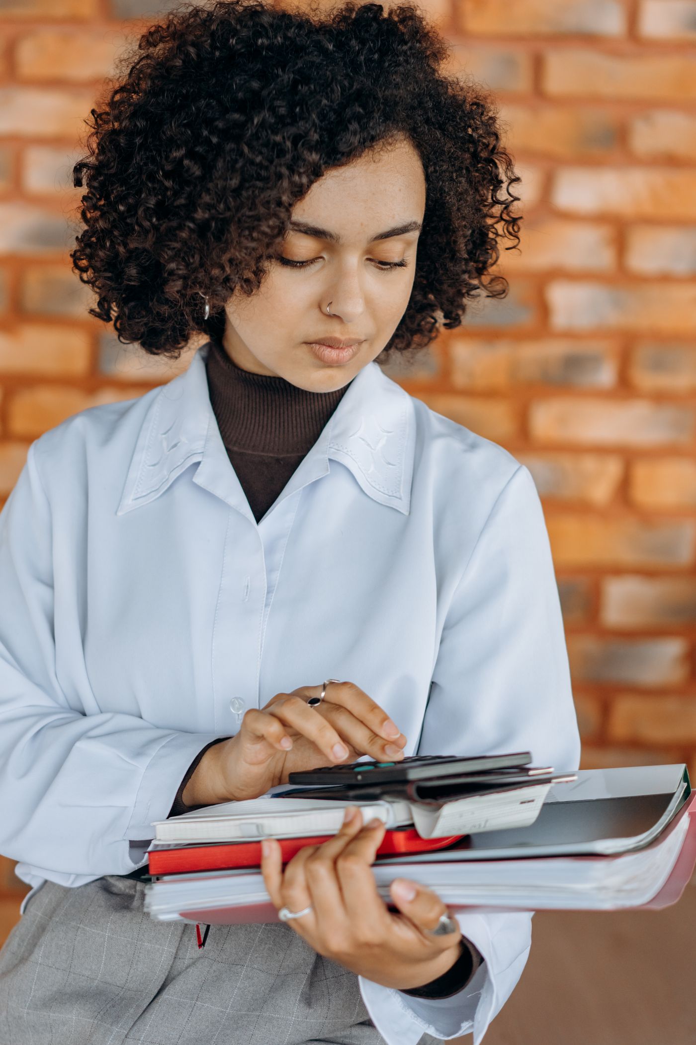 Business owner reviewing corporate financial records with a calculator