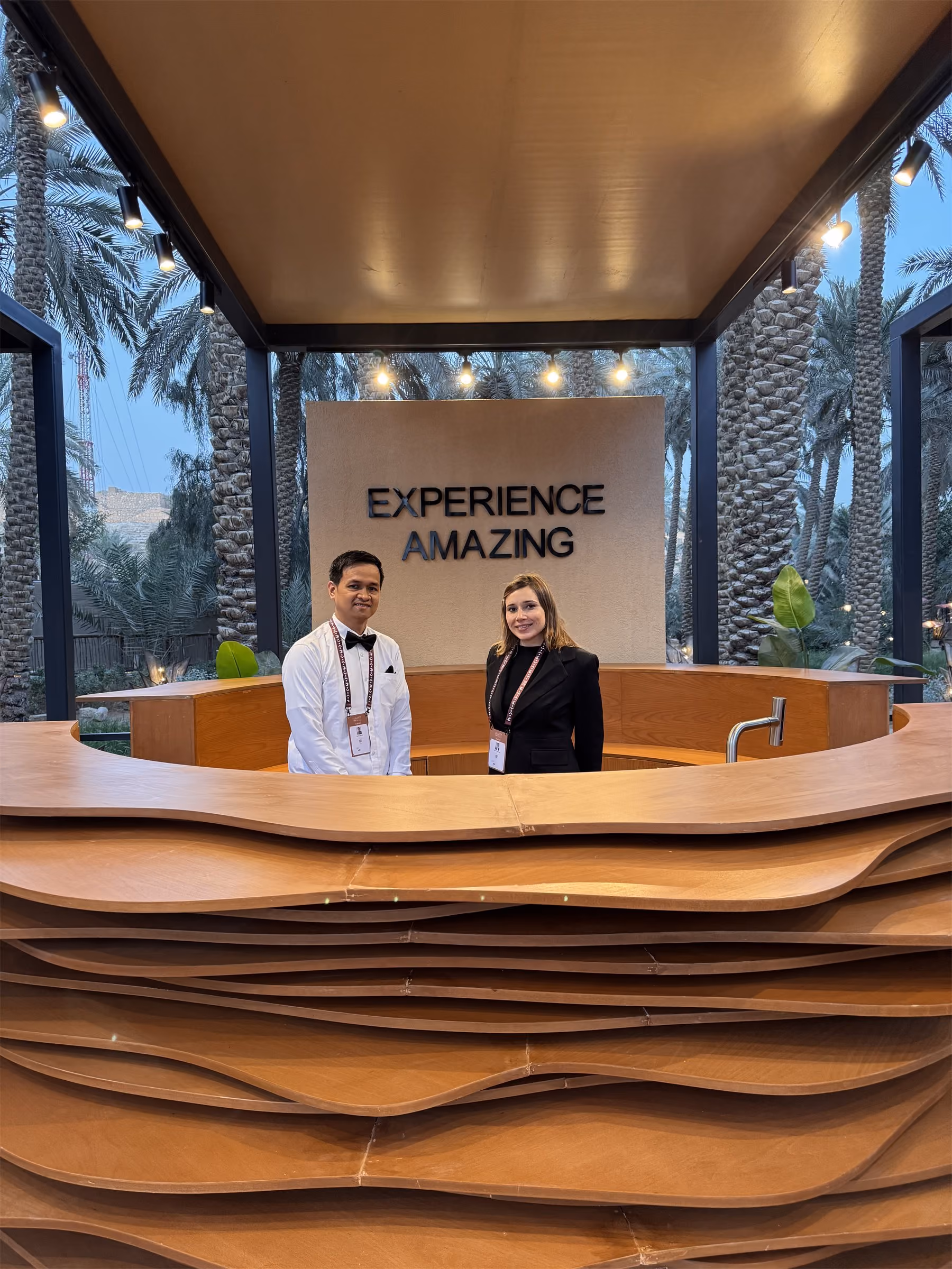 Host greeting guests at a hotel welcome desk