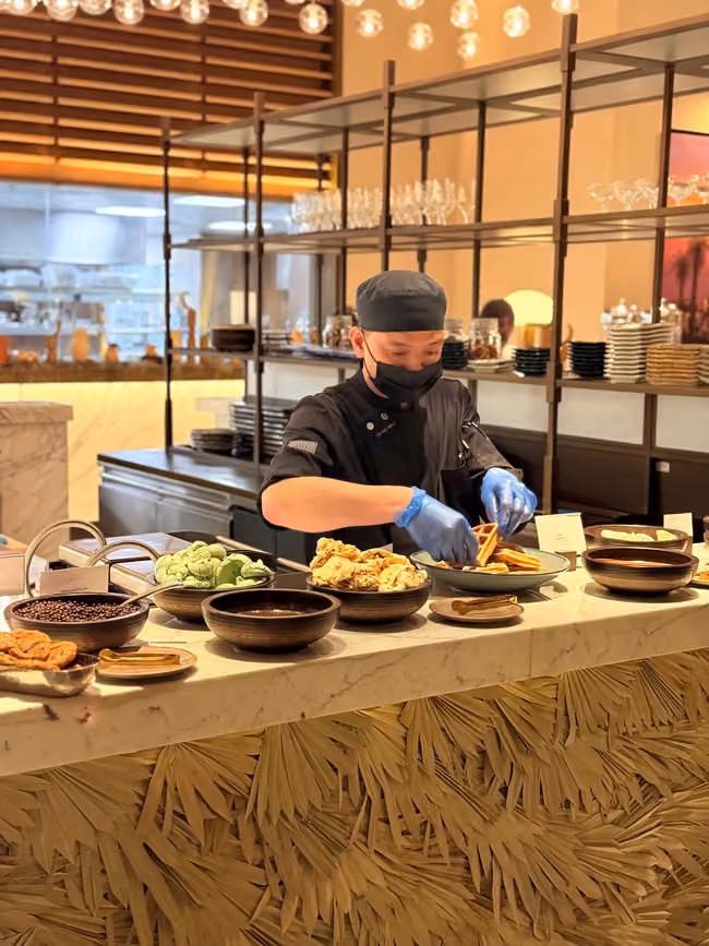 Head waiter plating at the buffet during service at Spago Majilis