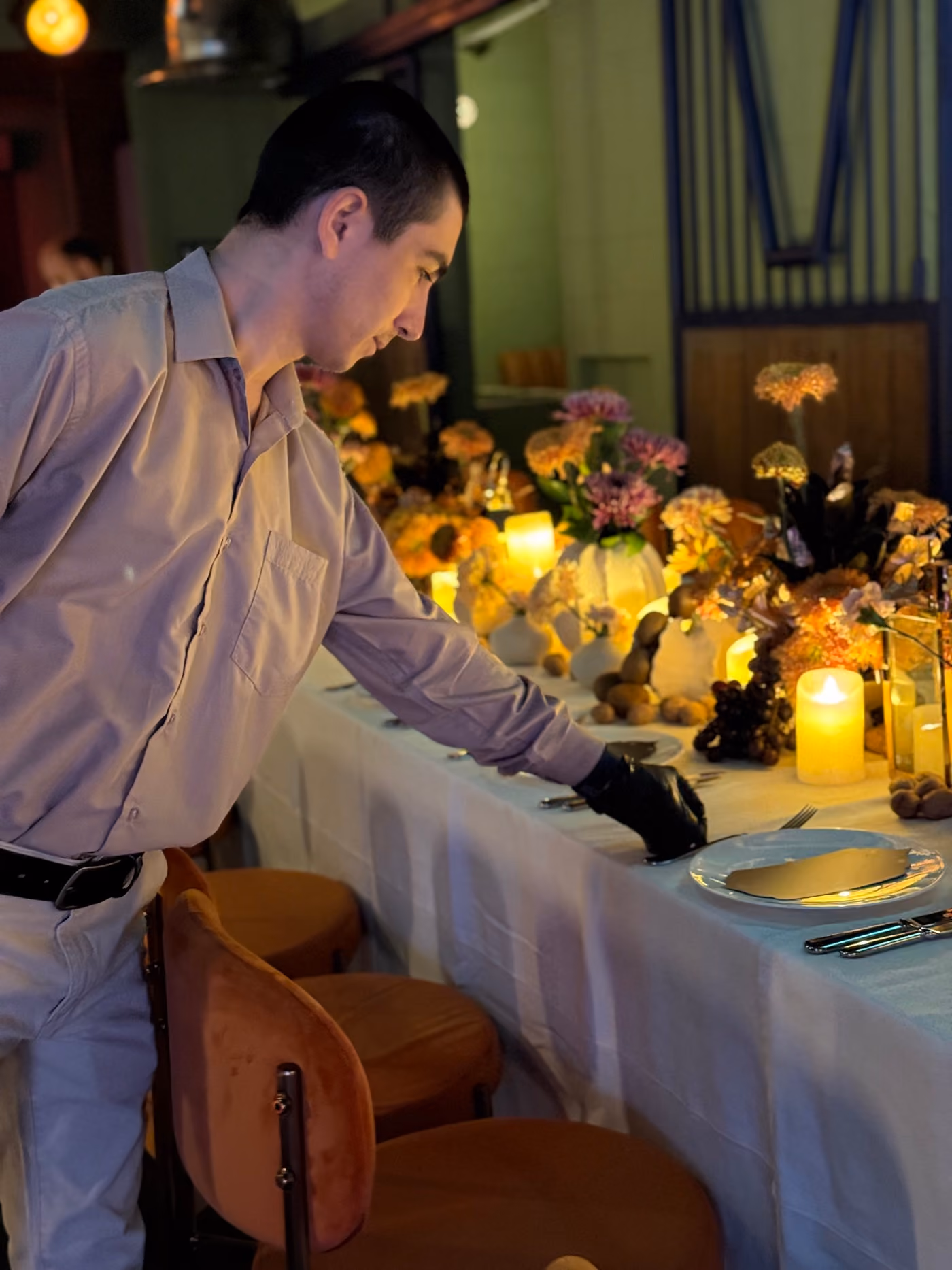 Melas team laying up a long candlelit table in an MDLBEAST venue
