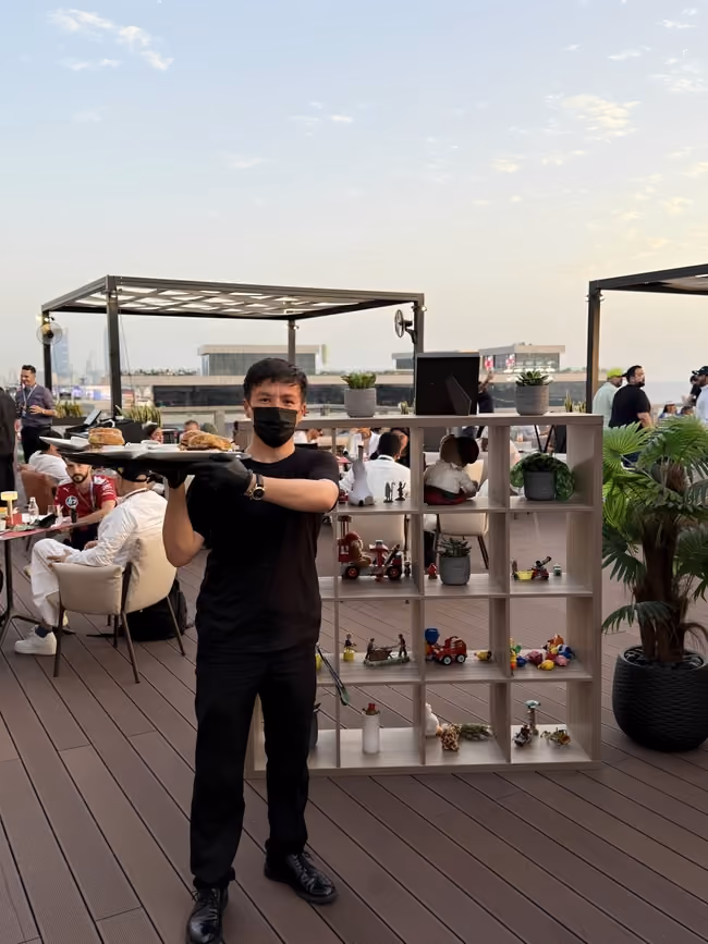 Guests seated in a rooftop hospitality suite overlooking the city