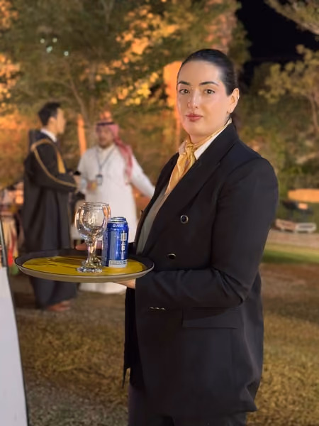 waiter in uniform standing looking at the camera