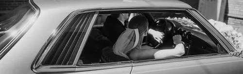 bride and groom driving in a classic mercedes