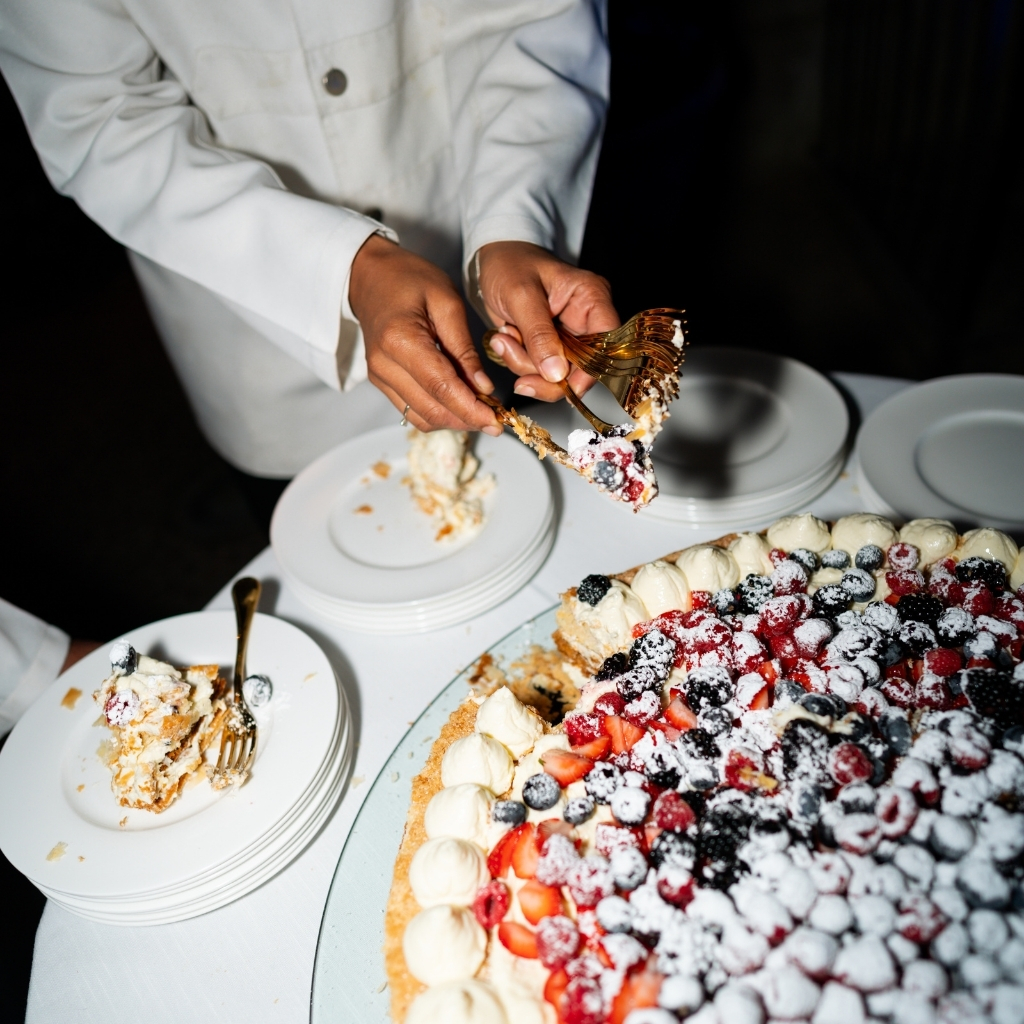 cutten of luxury wedding cake with fruit and cream
