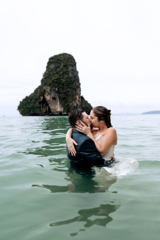 elopement wedding couple kissing while completely in water with wedding dress