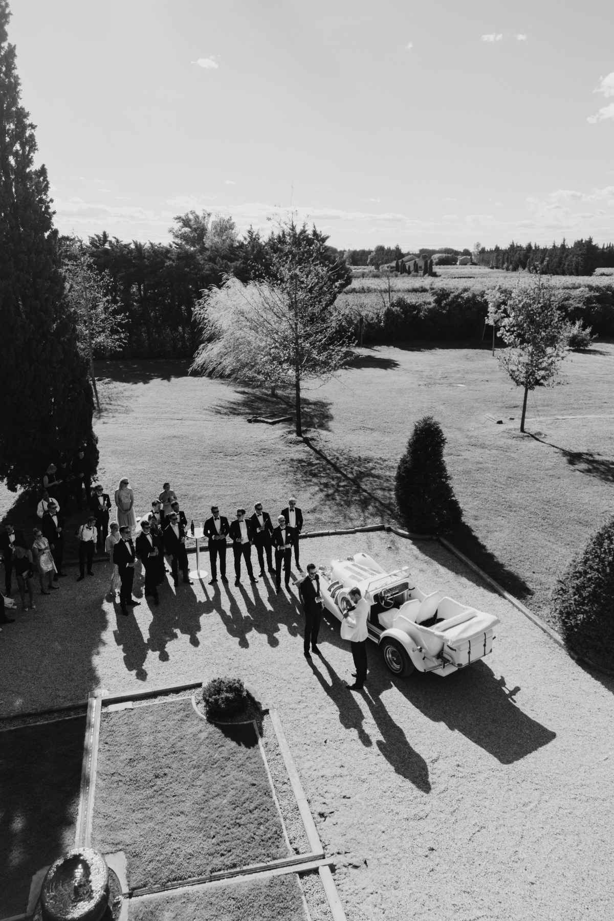 Newlyweds arriving in a vintage convertible at a luxury château wedding in the South of France
