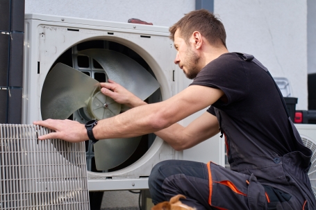Technician carrying out domestic appliance repairs on a tumble dryer fan in Bristol.