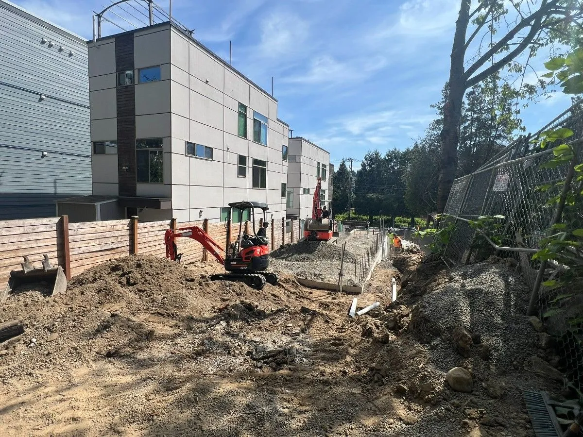 Excavator contractors digging for a foundation of a commercial building in Seattle