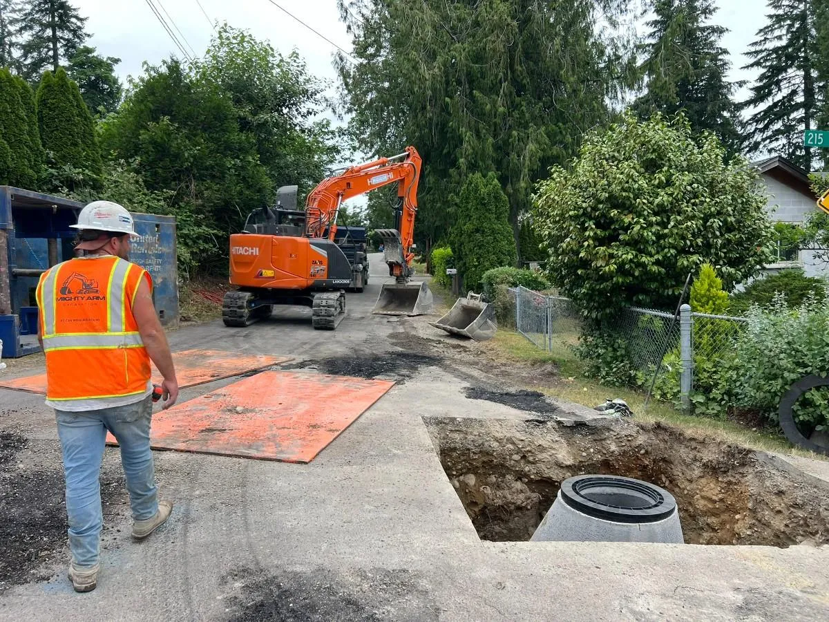 General contractor watching the process of storm drainage installation in Seattle