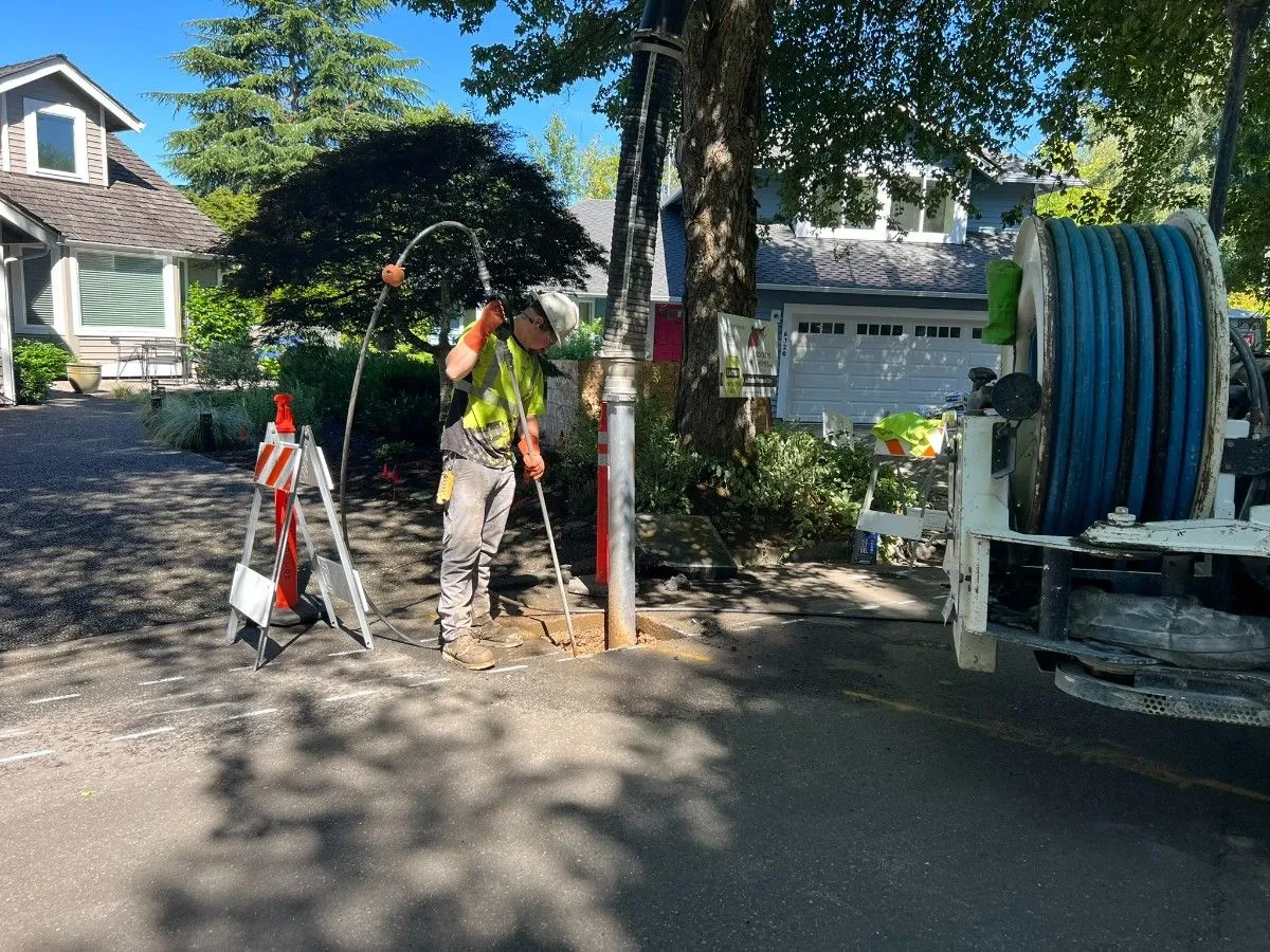 A contractor potholing in an excavated pavement for sewer inspection in Seattle