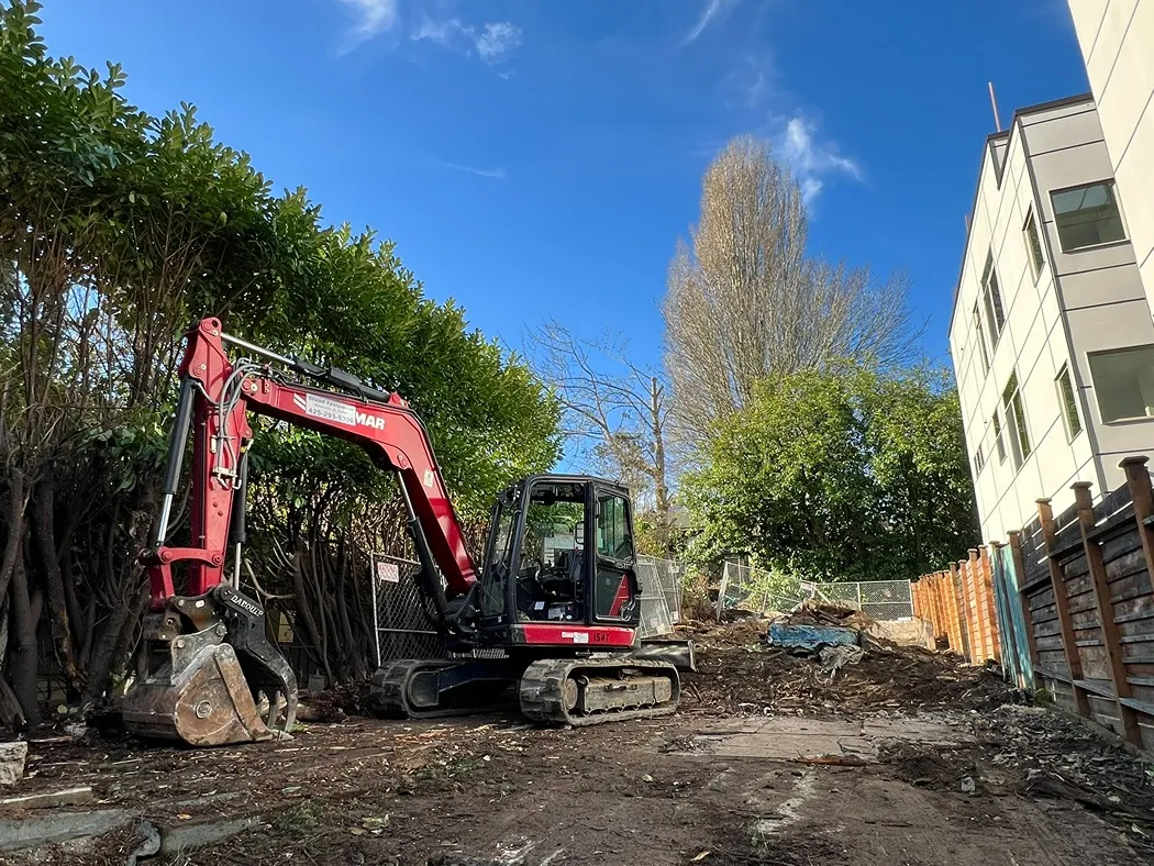 Excavator parked in an empty lot during earthwork process in Seattle