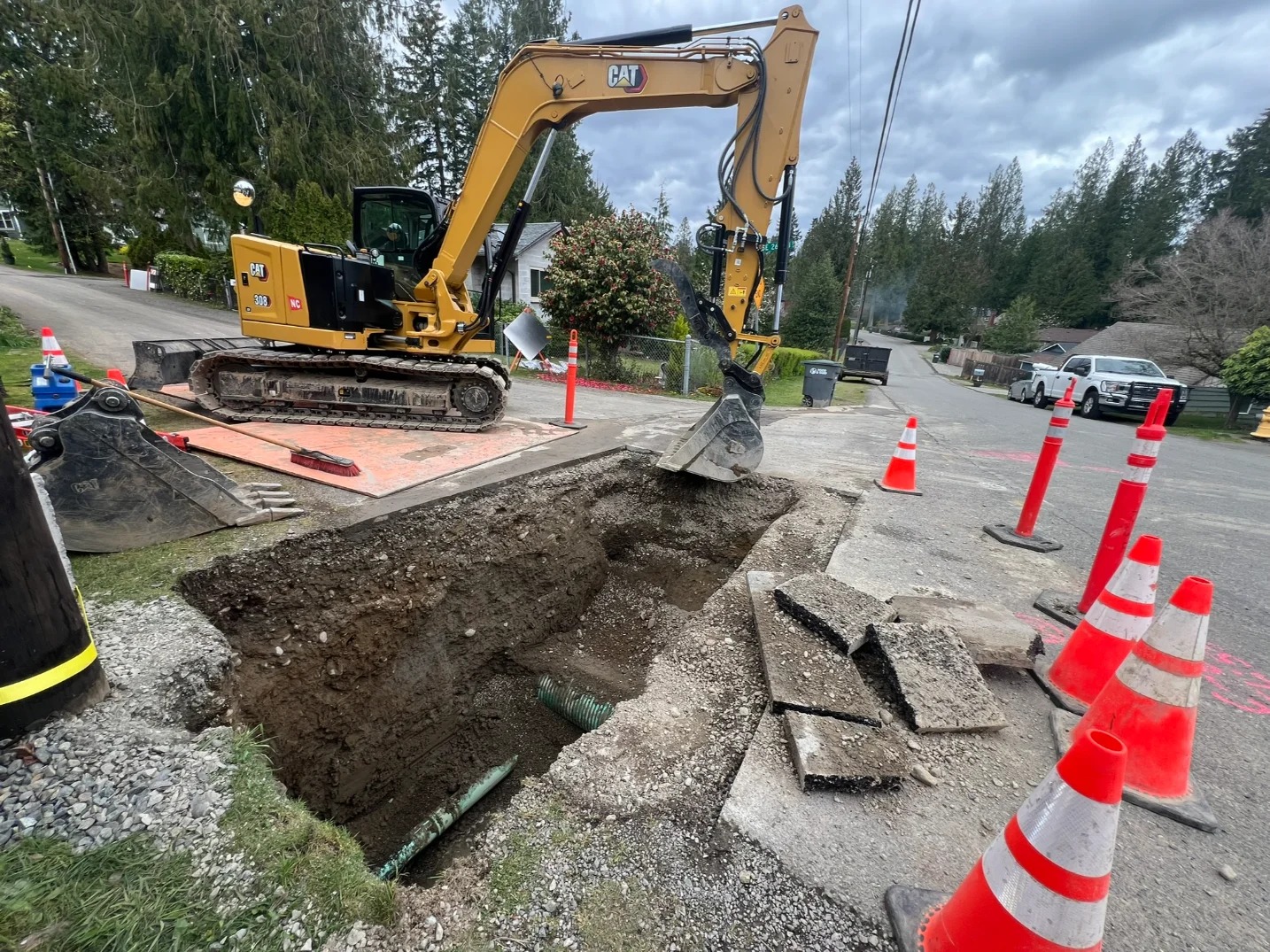 An open trench dug by an excavator for wet utility installation process