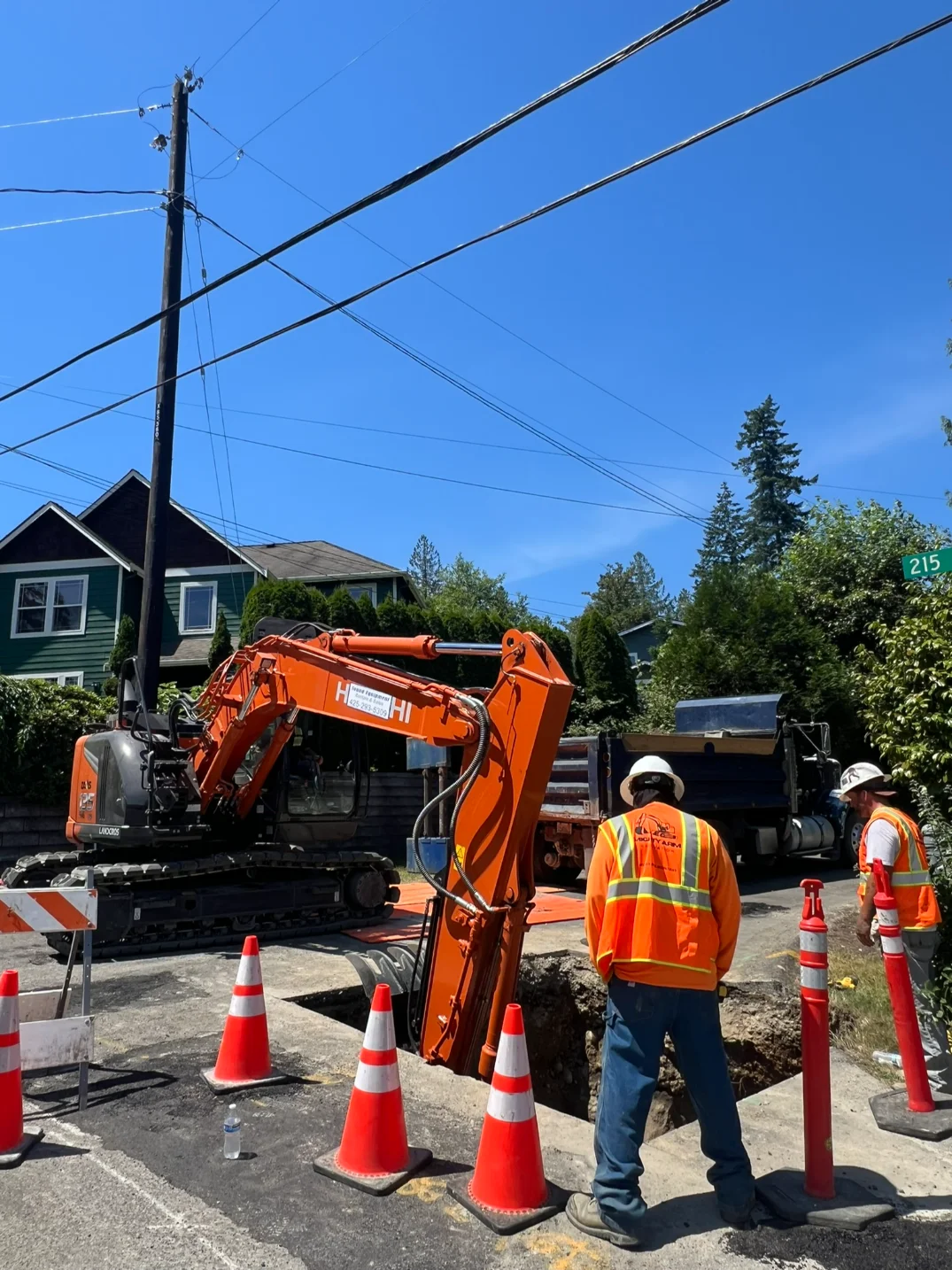 Contractors performing excavation for sewer line installation for a residential property in Seattle