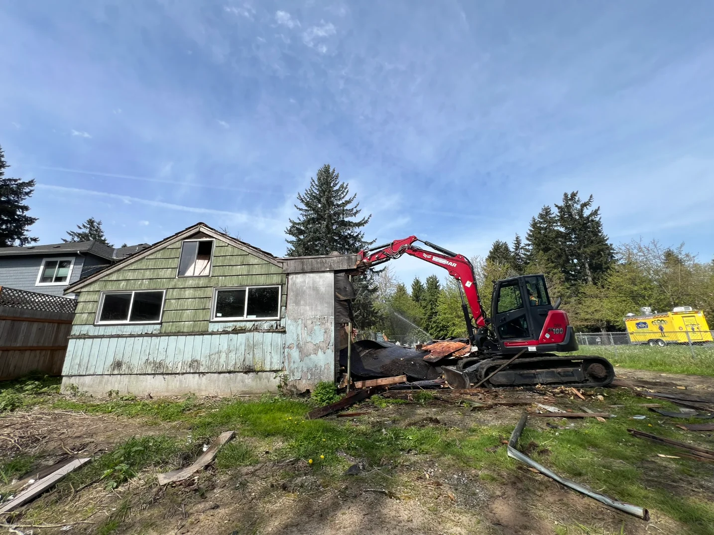An excavator beside a home to be demolished in Seattle