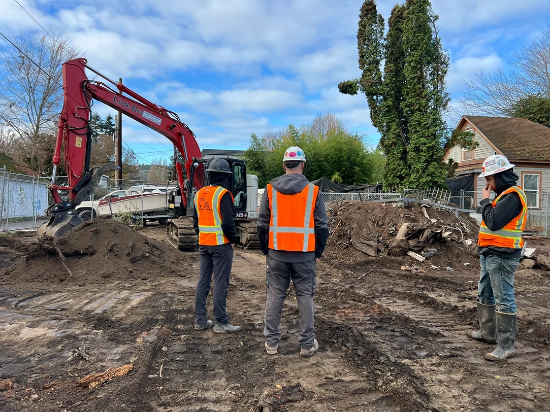 Excavator contractors discussing before they start clearing debris