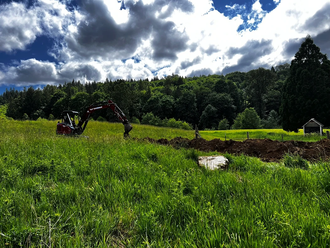 Trenches being dug by an excavator for utility installation in Seattle