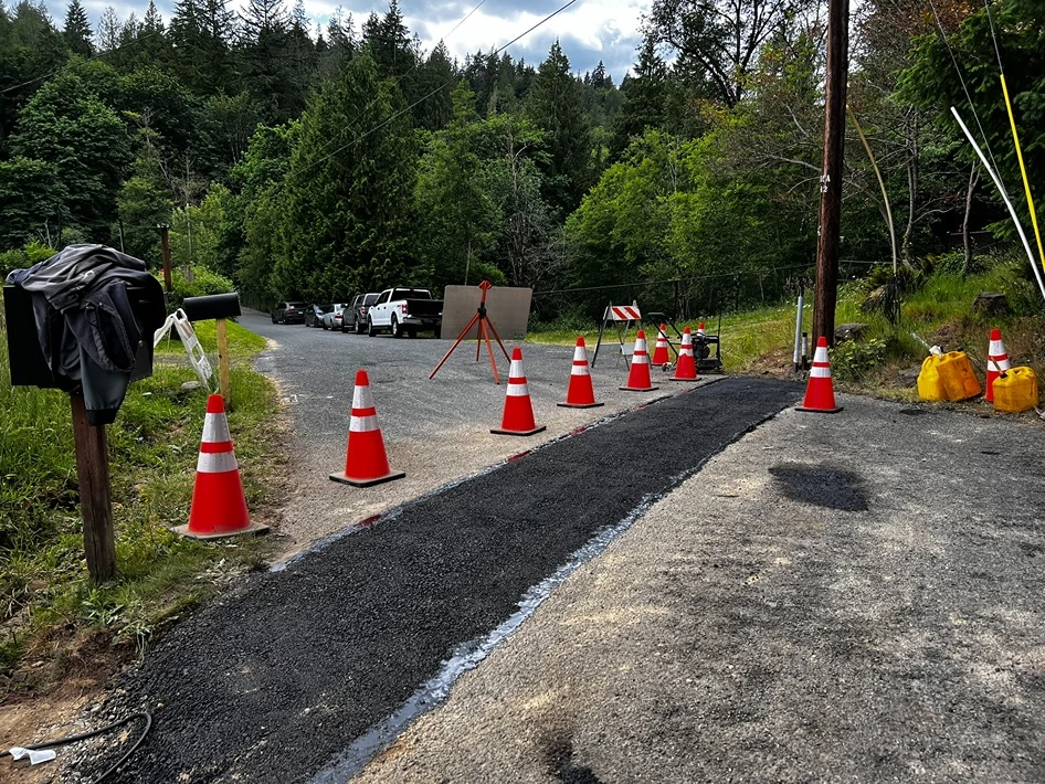 A trench covered with asphalt after installing electrical lines in Seattle