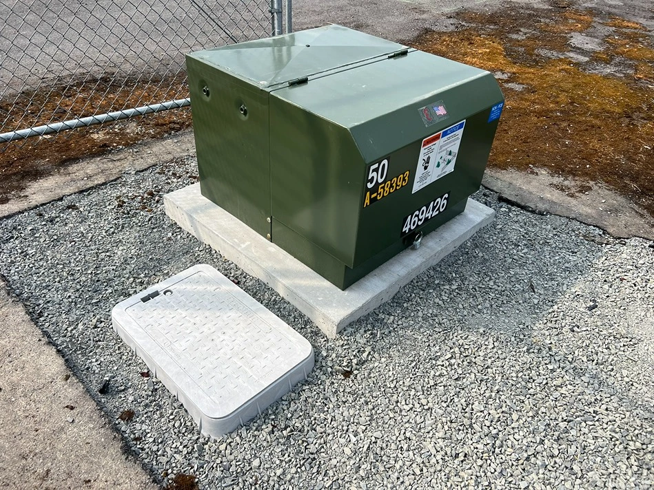 A newly installed electrical conduit next to a chain link fence in a Seattle property 