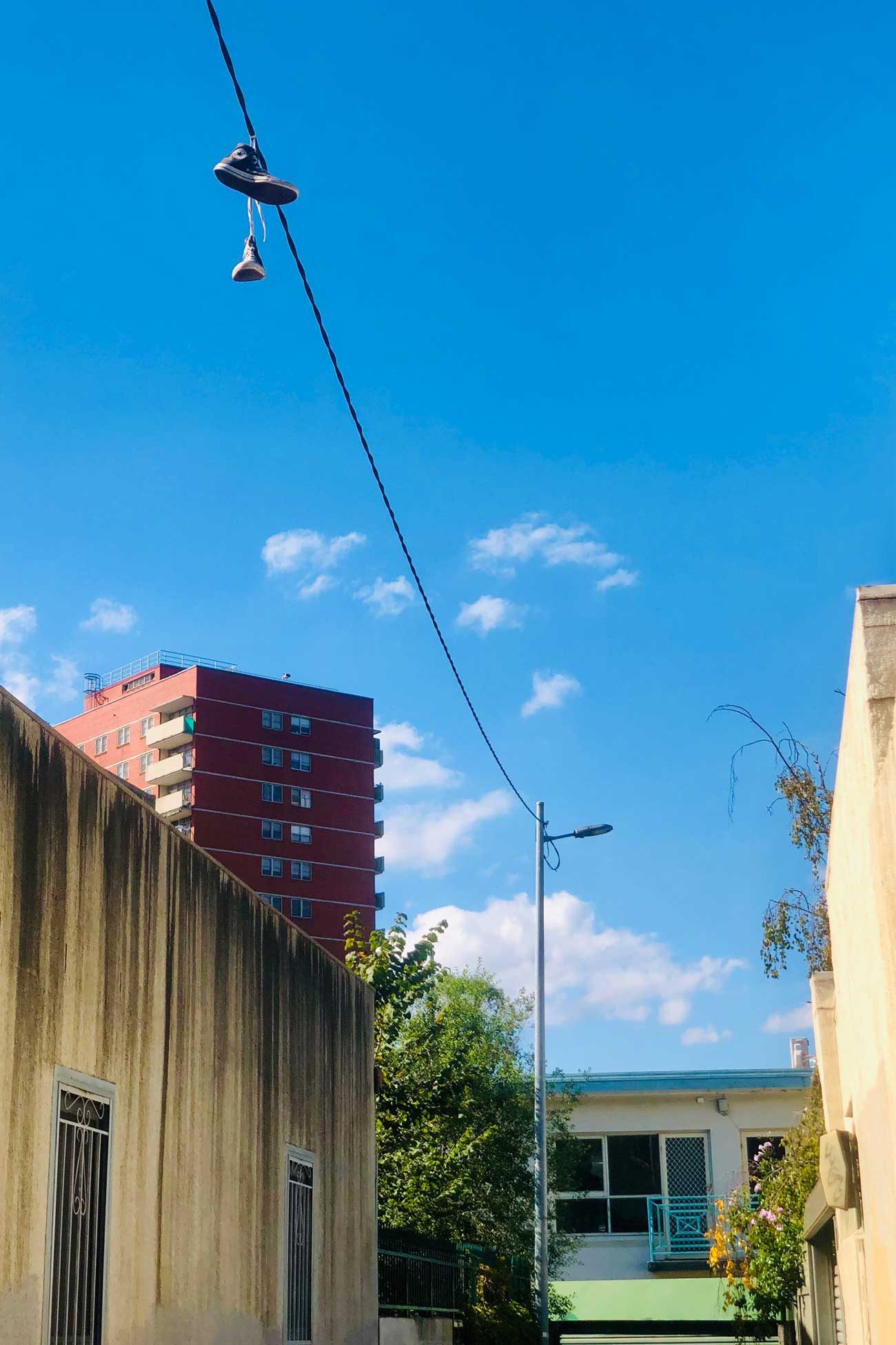 Melbourne laneway streetscape with a pair of shoes hanging from a power line