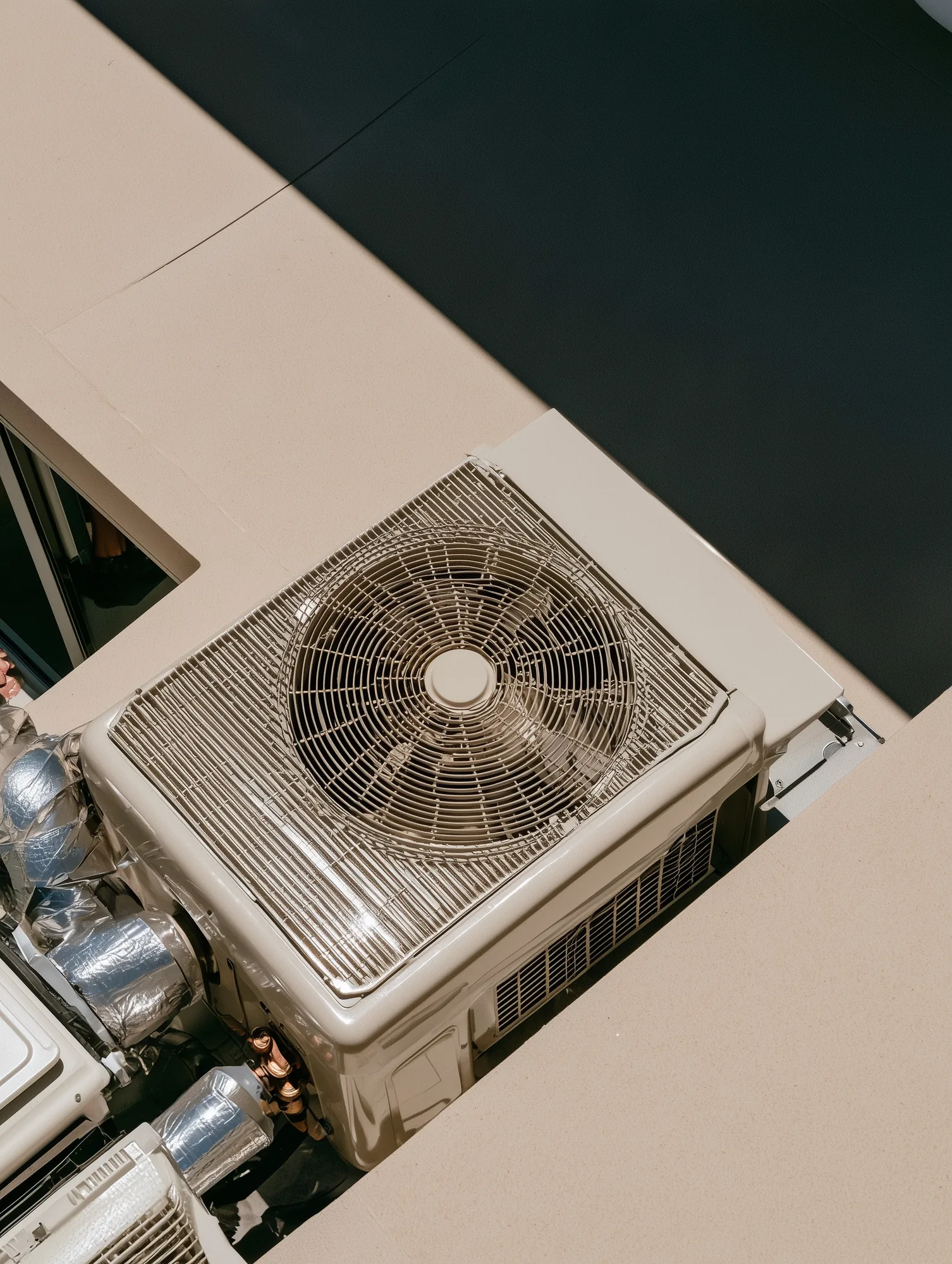 Commercial HVAC condenser unit seen from above on a rooftop.