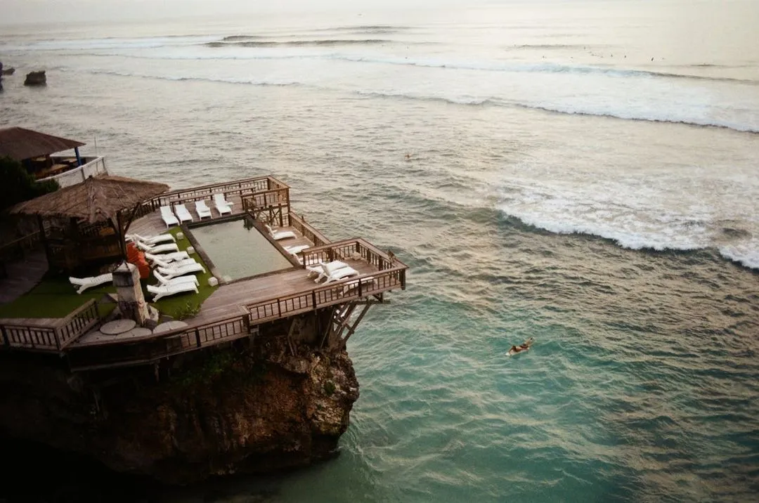 Views from the sea with a surfer with his surfboard.