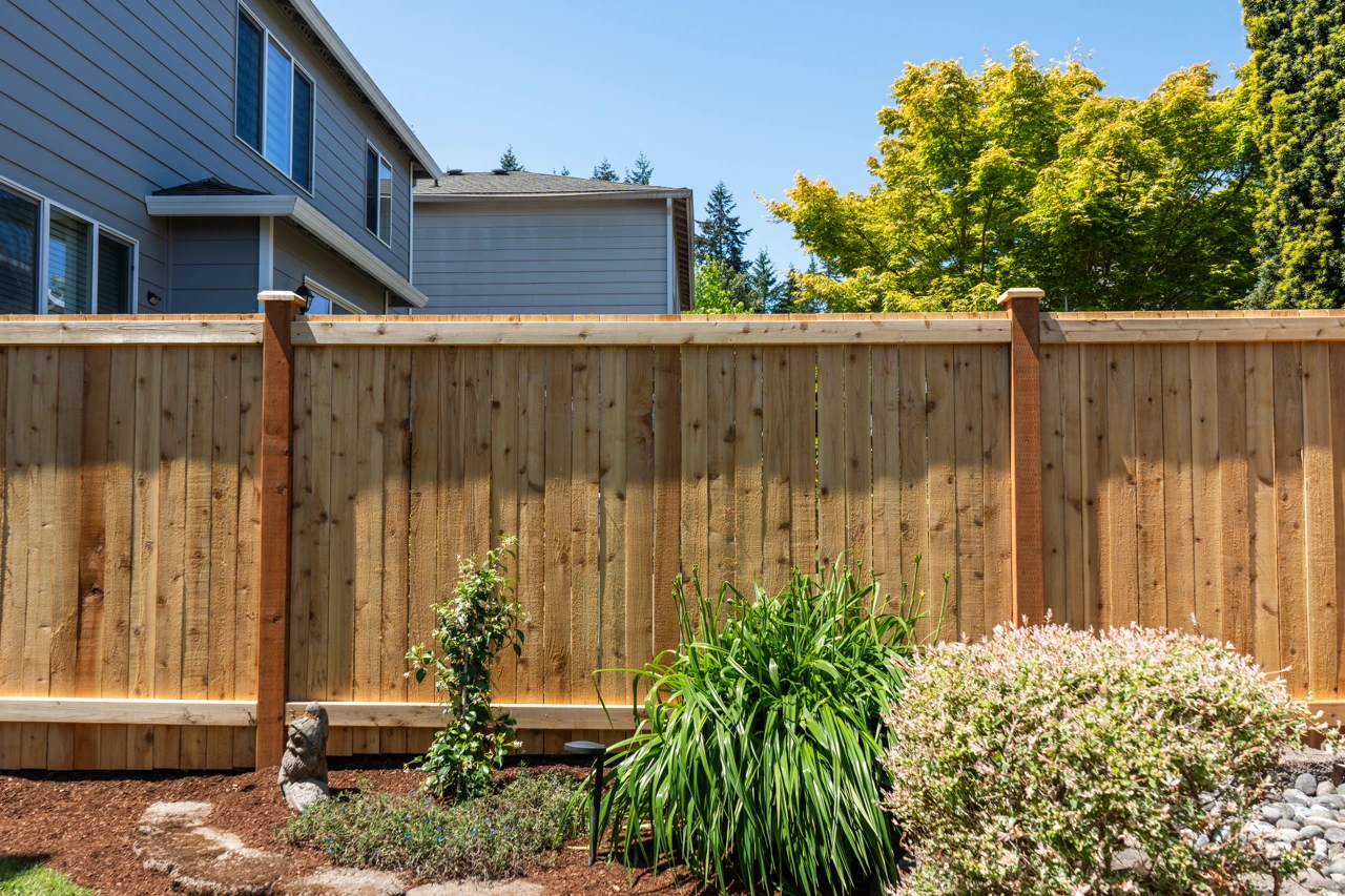 Fence contractor surveying a large property boundary line