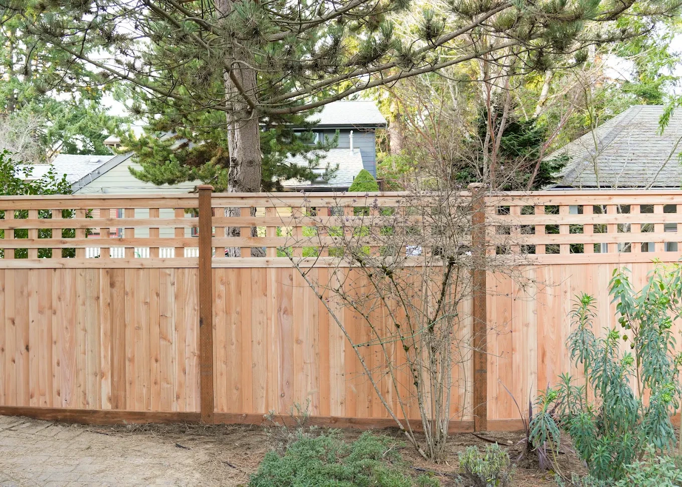 Satisfied homeowner reviewing their finished fence project